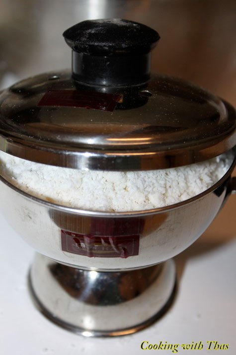 Puttu maker filled with wet rice flour