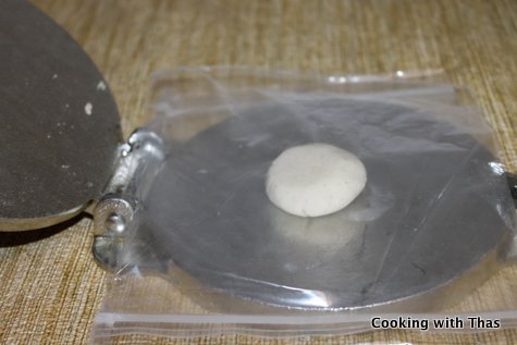 Tortilla dough on tortilla press