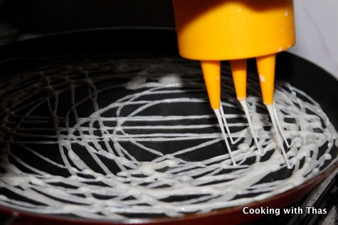 making roti Jala or Malaysian net crepe