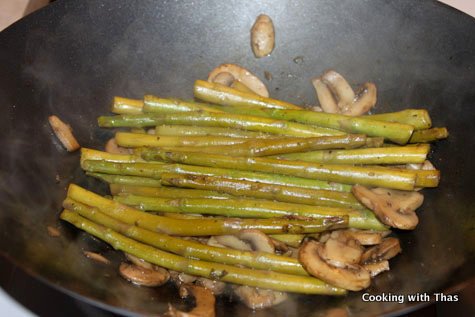 making asparagus mushroom stir fry