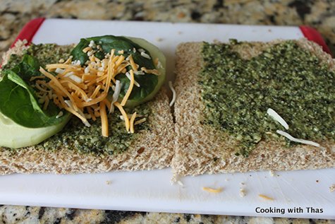 making pesto cucumber sandwich